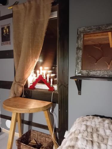 a room with a bed and a mirror and a stool at Experience accommadation Eco-Unela in Rovaniemi