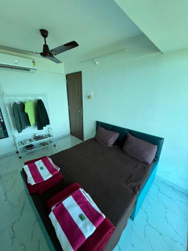 a bedroom with a bed with two towels on it at Panorama Seascape in Harnai