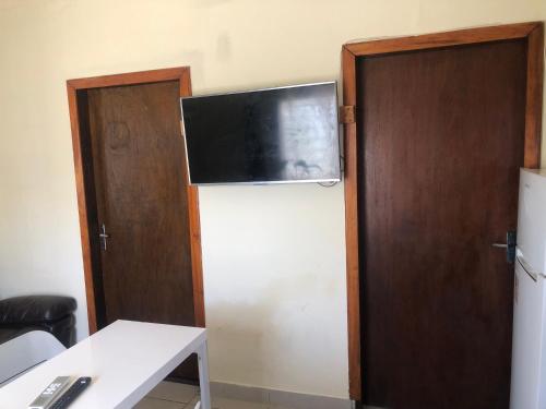 a room with a refrigerator with a television on top of it at Casa la Popa in Barra de Valizas
