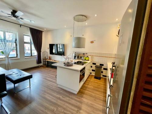 a kitchen with a white island in a room at 36 Phô Cô Hotel & Suites in Weimar