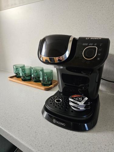 a black coffee maker sitting on a counter at Glebe Apartment in Campbeltown