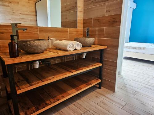 a bathroom with two sinks on a wooden shelf at Villa des trois singes in Saint-Pierre