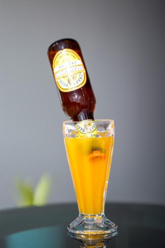 a bottle of beer is being poured into a glass at Mountain Vista Retreat in Nagarkot