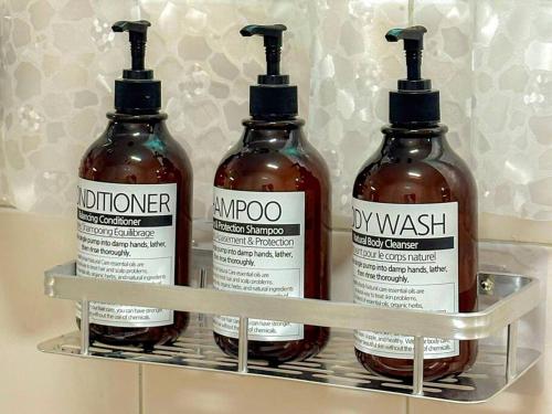 three bottles of hot sauce sitting on a shelf at Casa Choi 3 Bedroom Apartment in Seoul in Seoul