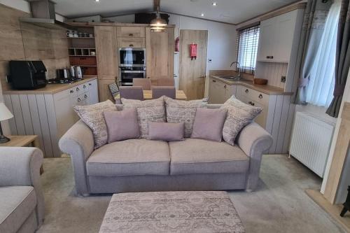 a living room with a couch in a kitchen at Ramblers Retreat in Cockermouth