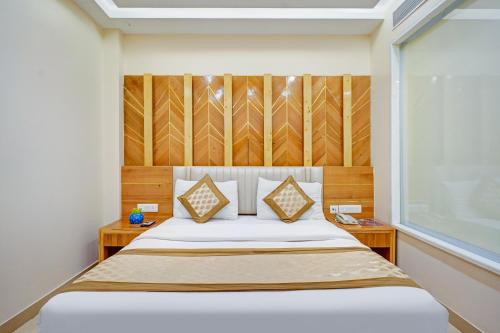 a bedroom with a bed with two tables and a window at Hotel Gold Palace - 03 Mins Walk From New Delhi Railway Station in New Delhi