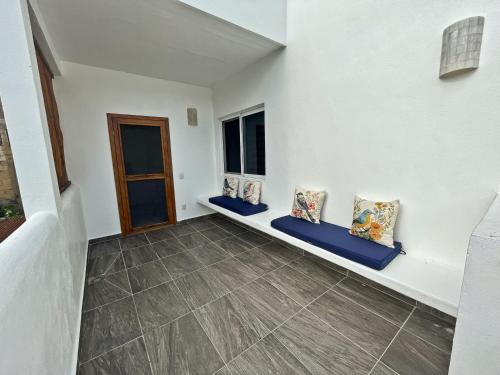 an empty room with two windows and a door at Blue Mahahual in Mahahual