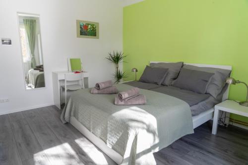 a bedroom with a bed with two slippers on it at WILSON's Home Baden City Center Rosengarden in Baden