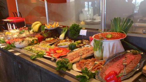 a buffet with a lot of different types of food at Hôtel Résidence du Golf in Calais