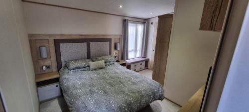 a bedroom with a large bed and a window at Ramblers Retreat in Cockermouth