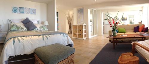 a bedroom with a bed and a living room at Avalon Horizons in Bilgola