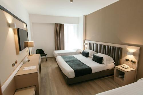 a hotel room with a bed and a desk at Grand Hotel la Chiusa di Chietri in Alberobello
