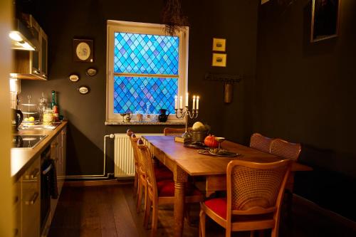 ハンブルクにあるWizard Apartment Hamburg - 3 Schlafzimmer - 156 qm mit Dachterrasse - bis 10 Personen - Dusche & Badewanne - kostenloser Parkplatzのキッチン(木製テーブル、椅子、窓付)