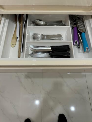 a drawer filled with utensils in a cabinet at Apartments Funtana with pool in Funtana