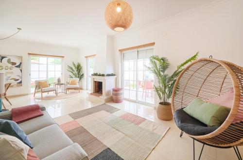 a living room with a couch and a swing at Beach & Cascais Luxury Villa, By TimeCooler in Alcabideche