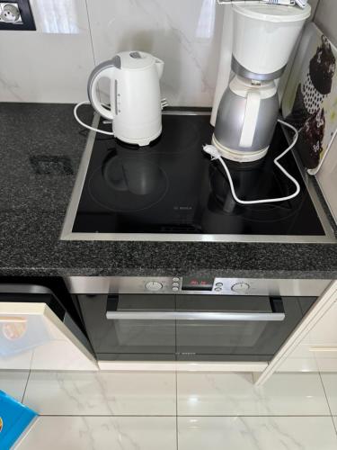 a stove top with a coffee maker on top of it at Apartments Funtana with pool in Funtana