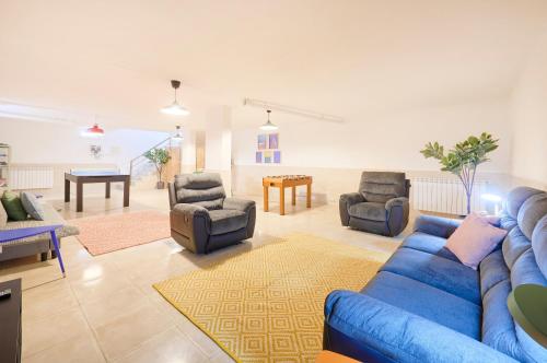 a living room with a blue couch and chairs at Beach & Cascais Luxury Villa, By TimeCooler in Alcabideche