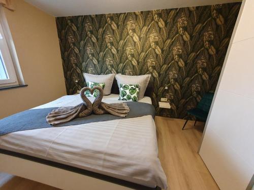 a bedroom with a large bed with a wall mural at Ferienwohnung-Thale-Ritter in Thale