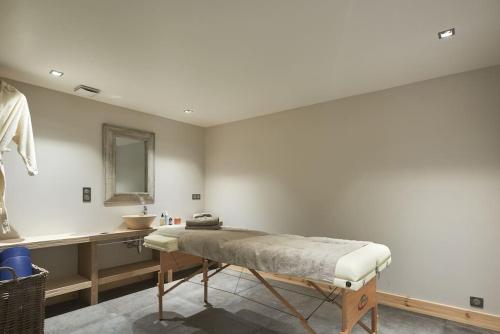 a room with a bed and a sink and a mirror at FRGK "Chalet de Prestige" in Saint-Étienne-de-Tinée