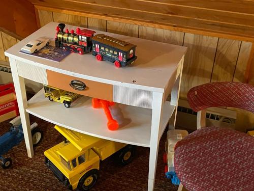 a white table with a toy train on top of it at White Owl Retreat Yellowstone Grand Teton in Island Park