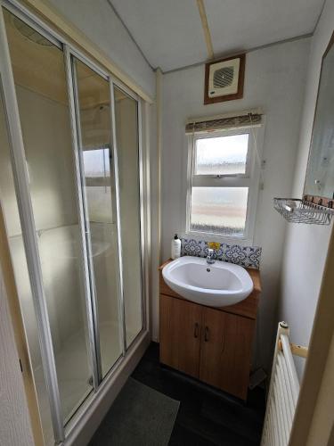 a bathroom with a sink and a shower at Skegness North Shore Holiday Park 8 Berth 3 Bedrooms in Skegness