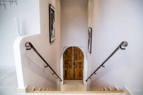 un escalier avec une porte en bois dans un bâtiment dans l'établissement Villa l'Angelus - Prestigious renovated property, à Noves