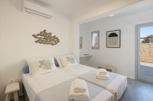 Postel nebo postele na pokoji v ubytování Paros Melodia Apartments