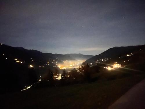 a view of a city lit up at night at Sonnalm Panoramablick in Rohrberg