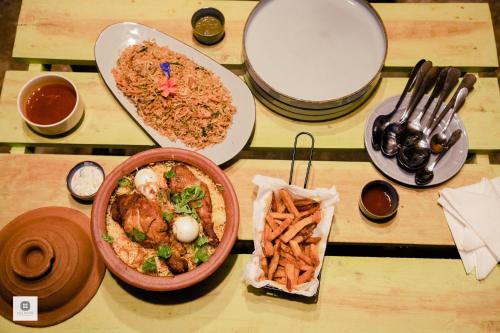 a table topped with bowls of food on a table at Walawwa Matale in Matale