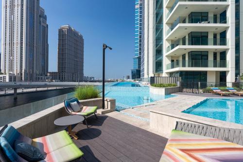 a swimming pool in a city with buildings at Luxury 1 & 2 BHK Apartments, Branded & State of The Art Amenities in Dubai