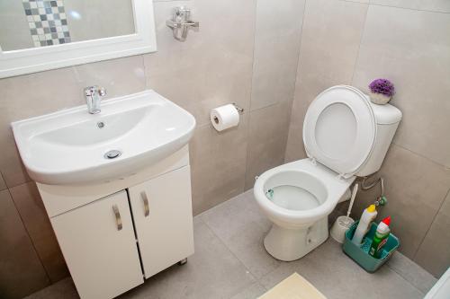 a bathroom with a toilet and a sink at Home 458 Easy Stay in Lusaka