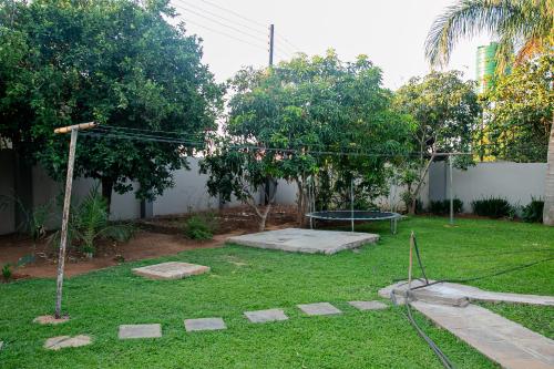 a backyard with a swing set in the grass at Home 458 Easy Stay in Lusaka