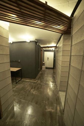 an empty room with a hallway with a table in it at That House Hongdae in Seoul