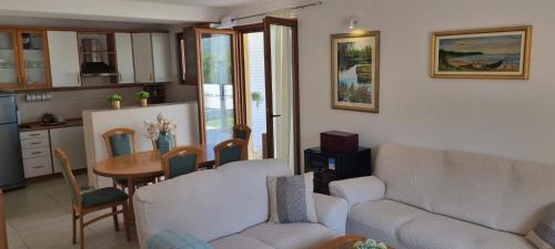 a living room with a couch and a table at Villa Korta Regina in Ston