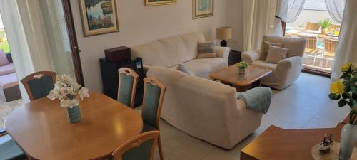 a living room with a couch and a table and chairs at Villa Korta Regina in Ston