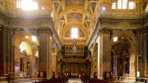 a large building with a church with pews in it at The First Luccoli Garibaldi Rolli in Genova