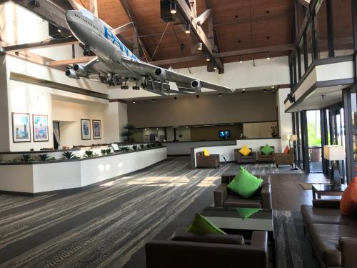 an office lobby with couches and a plane on the ceiling at Airtel Plaza Hotel in Van Nuys