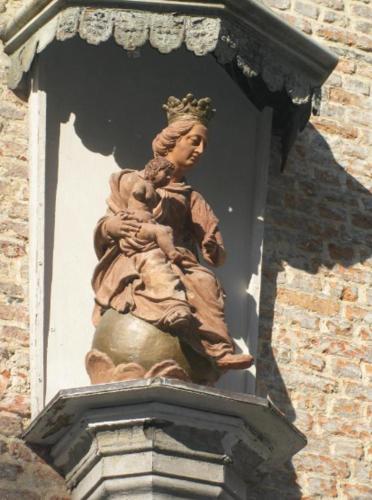 a statue of a woman on top of a building at Living History - Drie Koningen in Antwerp
