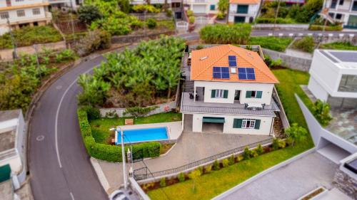 a model house with an orange roof and a road at Casa Dolce Vita in Ponta do Sol