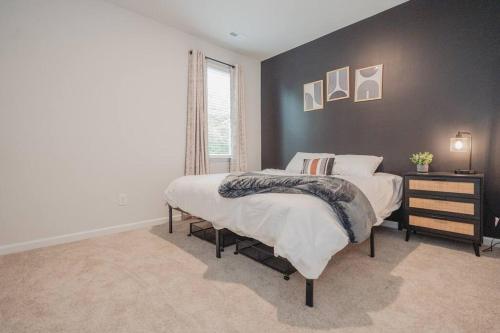 a bedroom with two beds and a black wall at 5BR 3B, Sleeps 13, Pet Friendly, Garage - Blue in Wilmington
