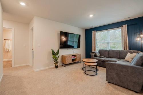 a living room with a couch and a table at 5BR 3B, Sleeps 13, Pet Friendly, Garage - Blue in Wilmington