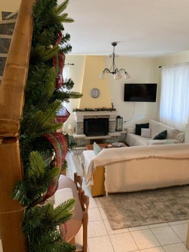 a living room with a christmas tree in the foreground at Madelulu House in Pramanta