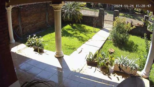 a porch with potted plants and a pole at Oma luisa in Obligado