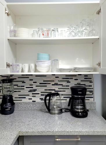 a kitchen counter with two coffee makers and dishes at Blue Water Villa in Point