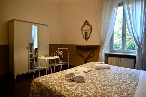 a bedroom with a bed with towels on it at Dimora Montecchi in Verona