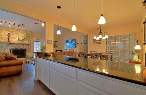 a kitchen and living room with a large counter top at Hidden Haven in Canyon Lake