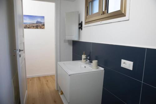 a bathroom with a white sink and a mirror at Spalti 33 in Trapani