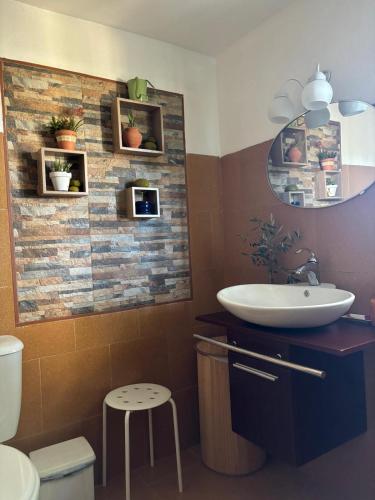 a bathroom with a sink and a mirror at Casa Celia in Miranda del Rey