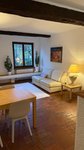a living room with a couch and a table at 2 bedroom apt near Como lake in Morbio Inferiore