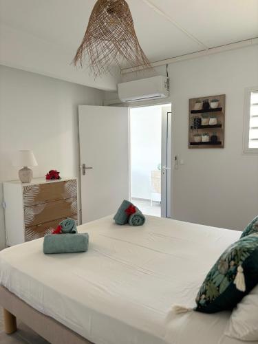 a large white bed with two pillows on it at Villa Ansalane in Quartiers Anse à lʼÂne